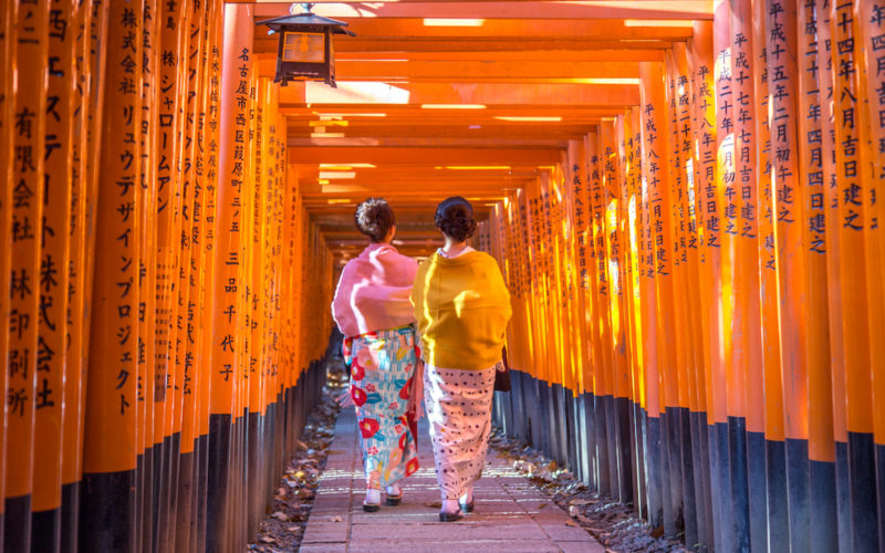 Kyoto, Japan - December 13, 2014: Two geishas walking through orange gates called torii at the Fushimi Inari Shrine (Kyoto, Japan - December 13, 2014: Two geishas walking through orange gates called torii at the Fushimi Inari Shrine, ASCII, 116 compon