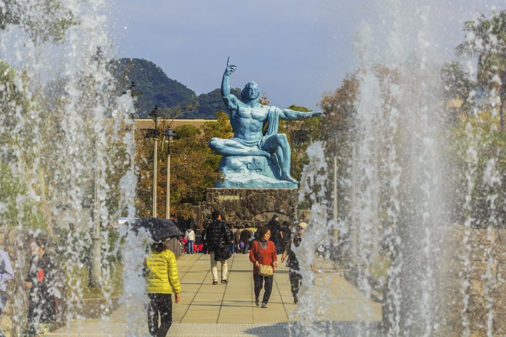 The Peace Statue in Nagasaki Park . The right hand points to the nuclear threat while the left hand represents the wish for peace.