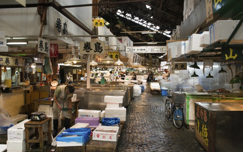 Tokyo, Japan - June 4, 2015: Retailers busy selling and packing seafood in Tsukiji market. It is the largest fish market in Japan.
